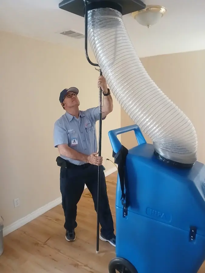 Furnace Tune-Up technician using HEPA equipment in Boerne